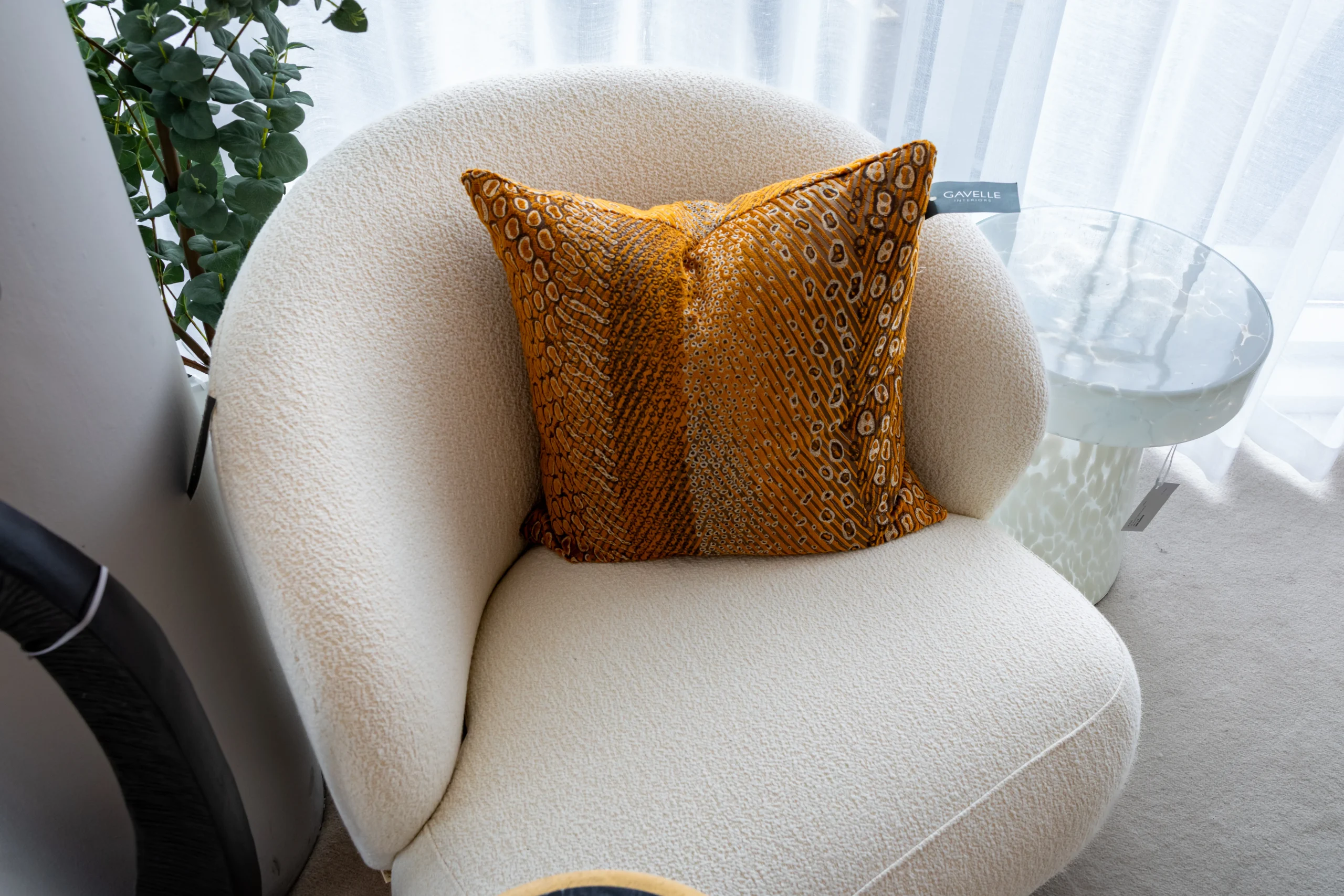 Cream boucle tub chair with amber velvet animal print cushion by Gavelle