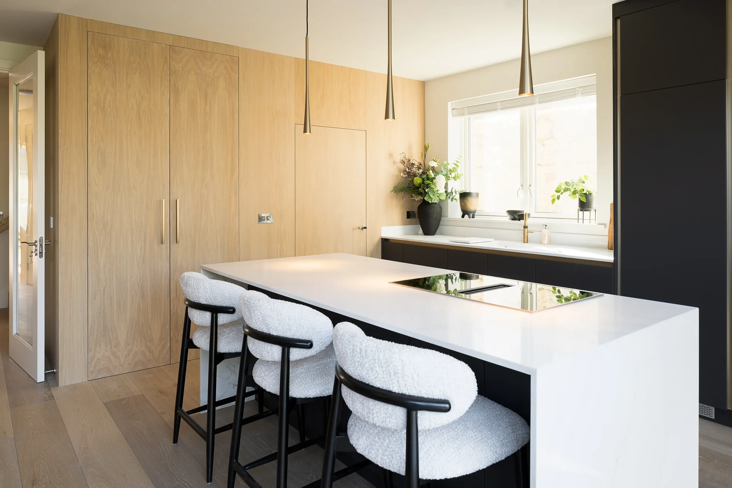 Interior design and joinery detail from the Blackrock home by Gavelle, in a palette of matte charcoal, warm oak, brushed brass and natural stone