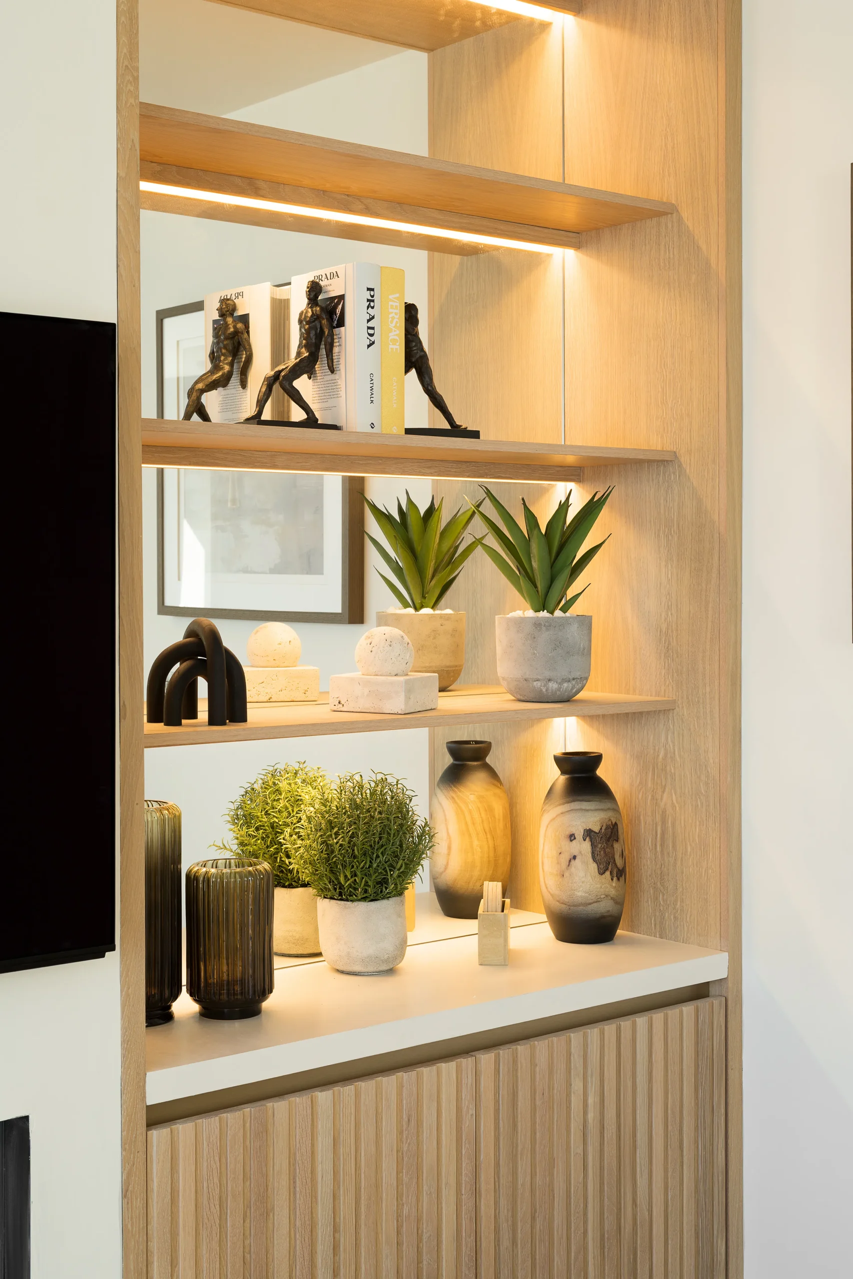 Interior design and joinery detail from the Blackrock home by Gavelle, in a palette of matte charcoal, warm oak, brushed brass and natural stone