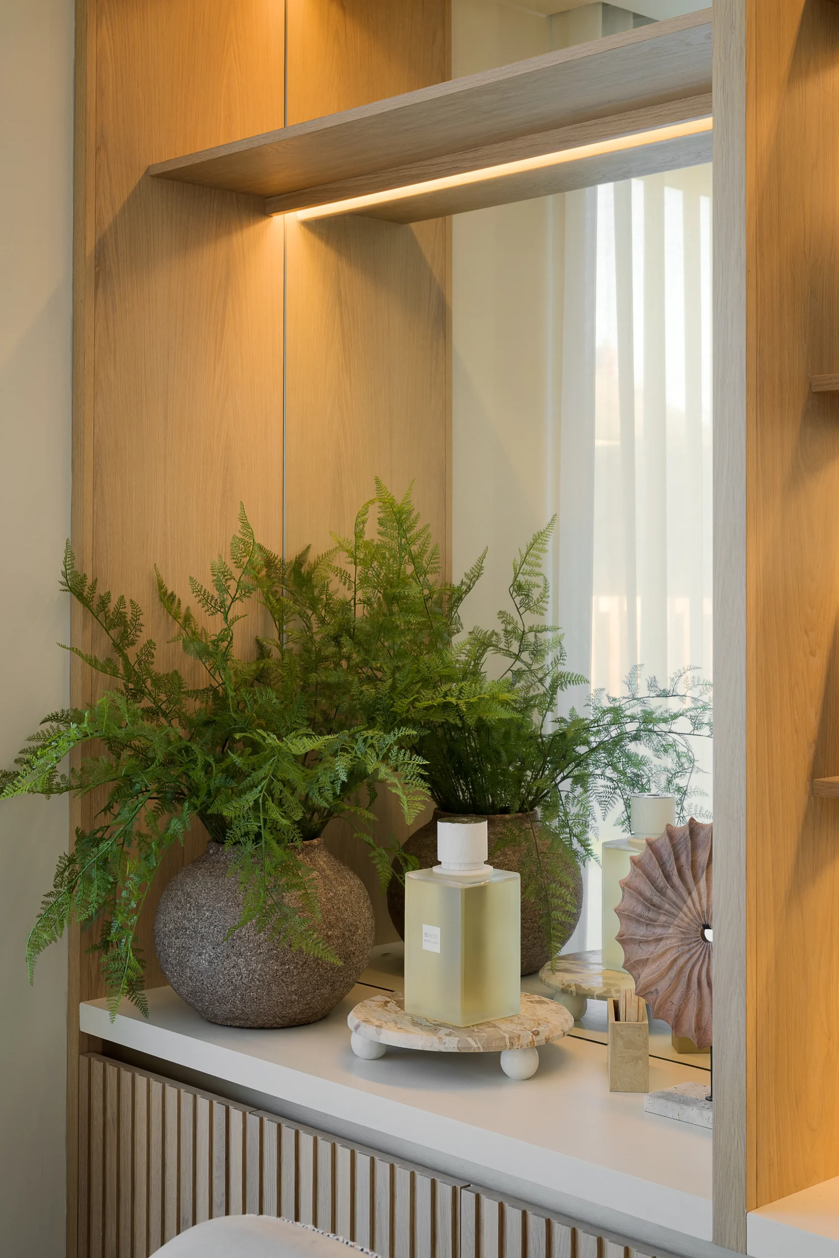 Interior design and joinery detail from the Blackrock home by Gavelle, in a palette of matte charcoal, warm oak, brushed brass and natural stone