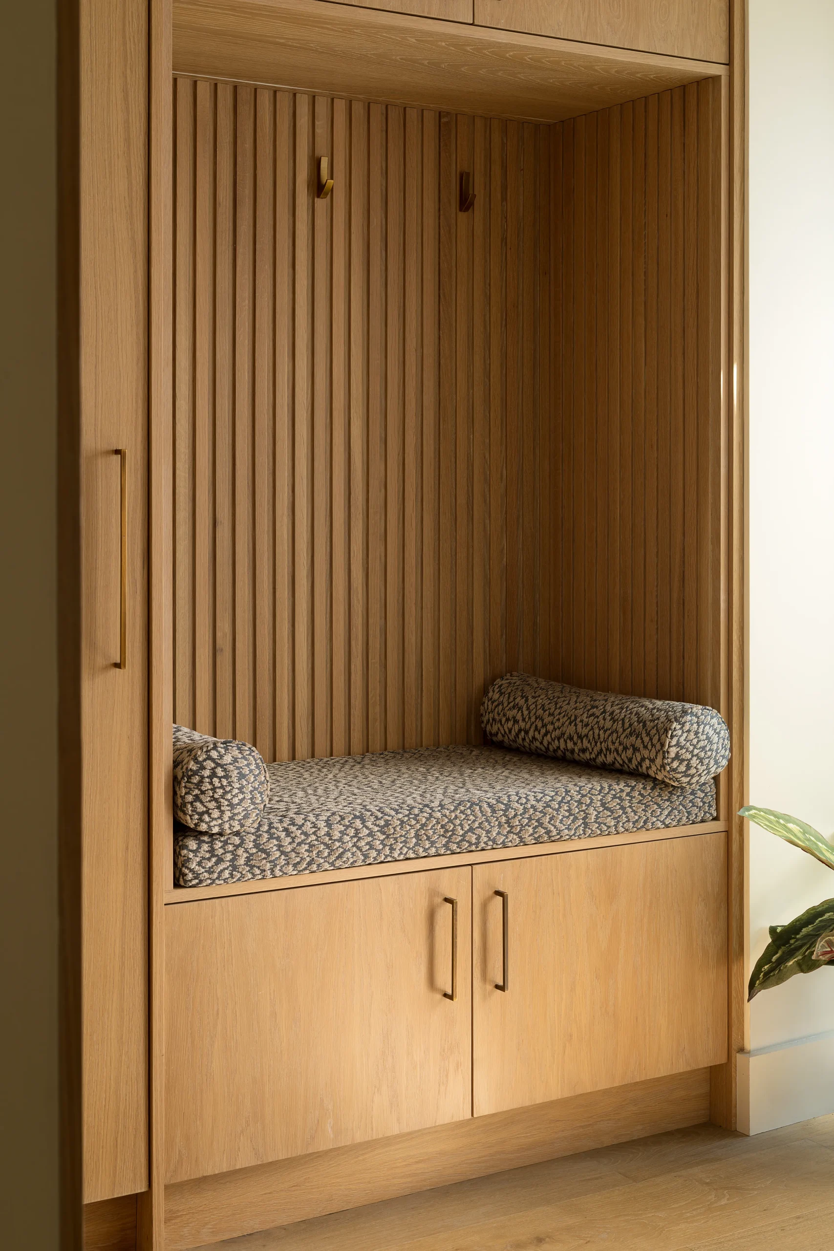 Interior design and joinery detail from the Blackrock home by Gavelle, in a palette of matte charcoal, warm oak, brushed brass and natural stone