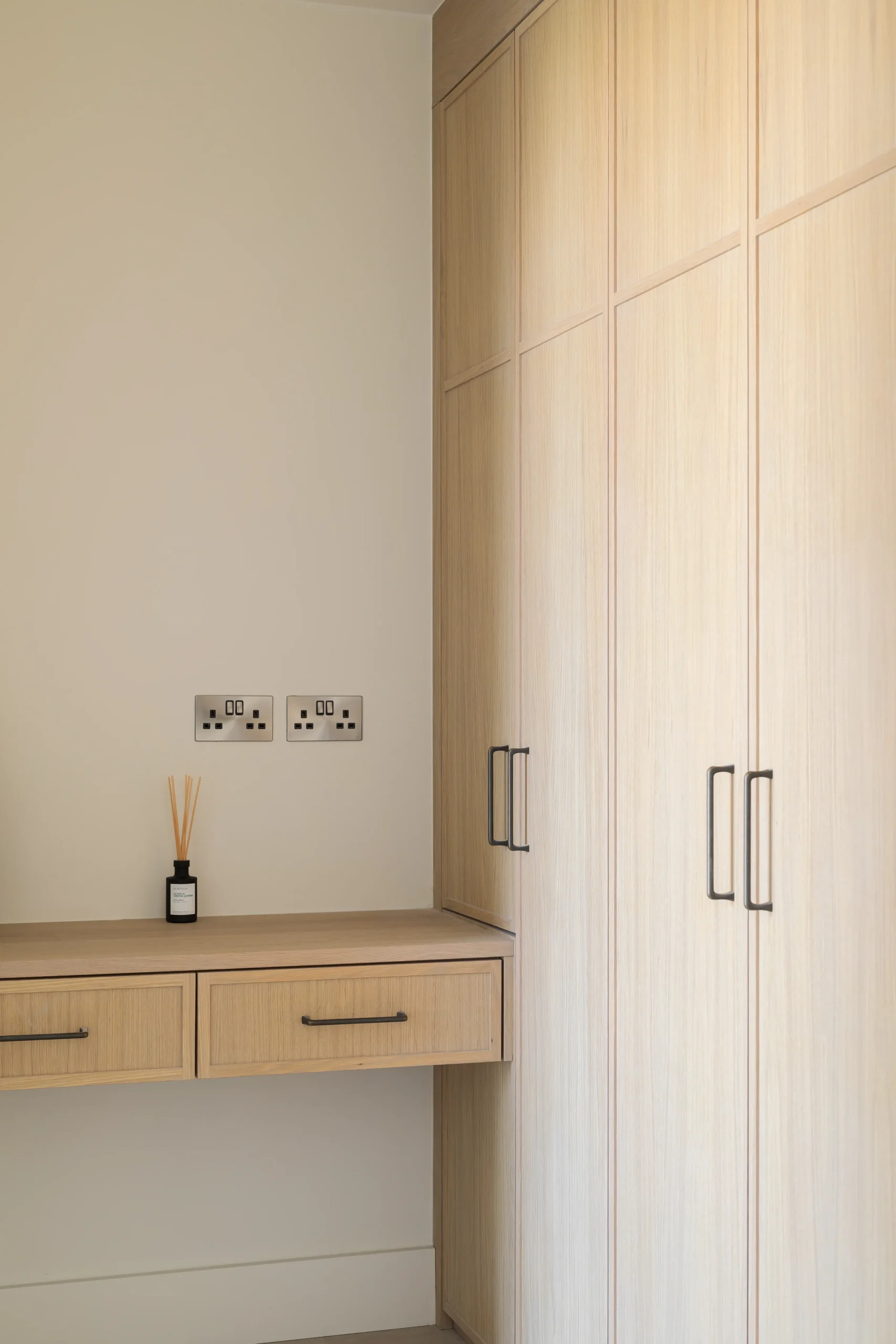 Interior design and joinery detail from the Blackrock home by Gavelle, in a palette of matte charcoal, warm oak, brushed brass and natural stone
